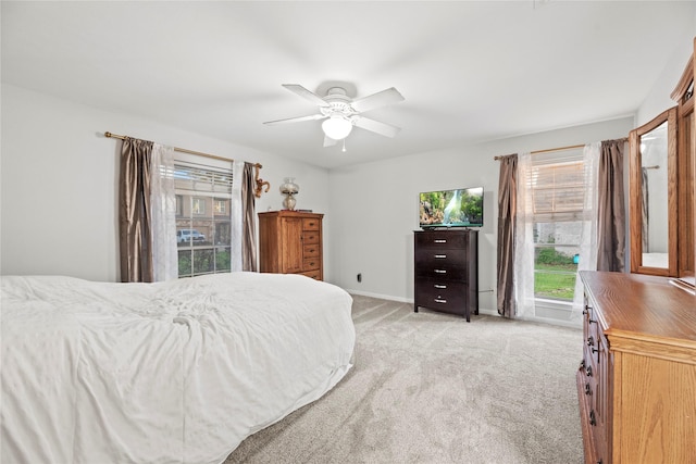 bedroom with light colored carpet and ceiling fan