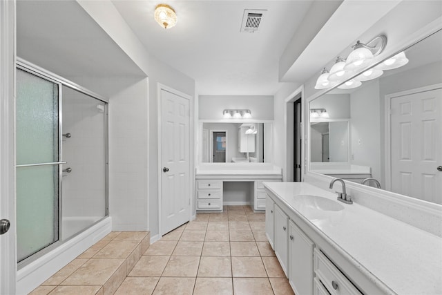 bathroom featuring vanity, tile patterned flooring, and a shower with shower door