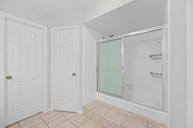 bathroom with walk in shower and tile patterned floors