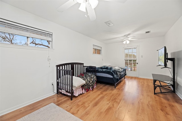 bedroom with ceiling fan and hardwood / wood-style flooring