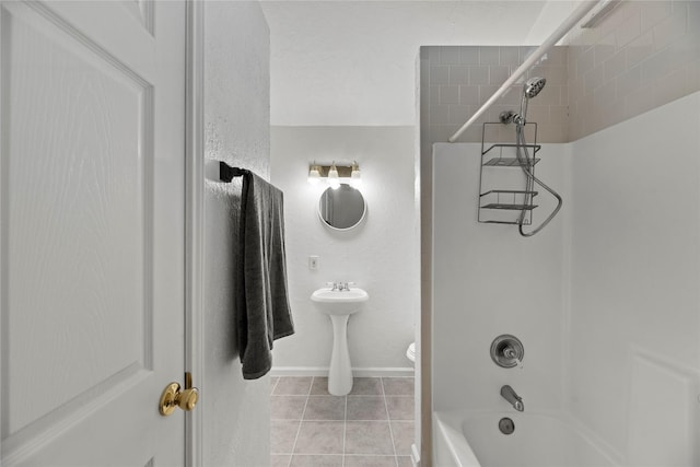 bathroom with toilet, shower / washtub combination, and tile patterned floors