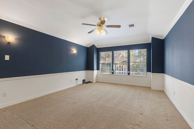 empty room featuring ceiling fan, lofted ceiling, crown molding, and light carpet