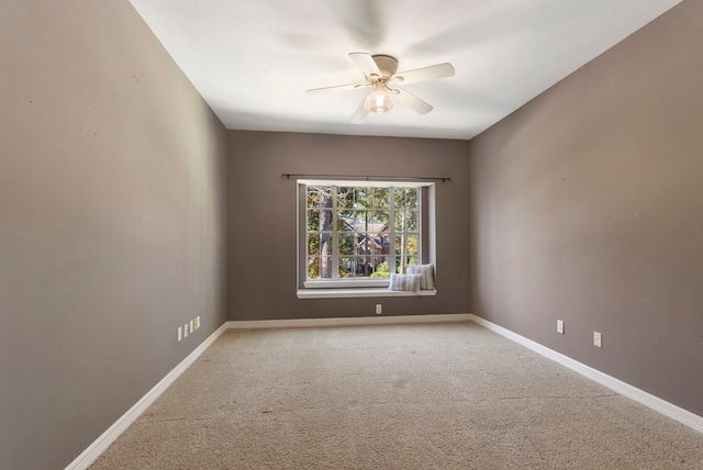 carpeted empty room featuring ceiling fan