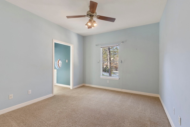 unfurnished room with ceiling fan and light carpet