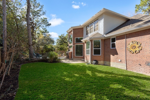 back of property featuring a lawn and a patio