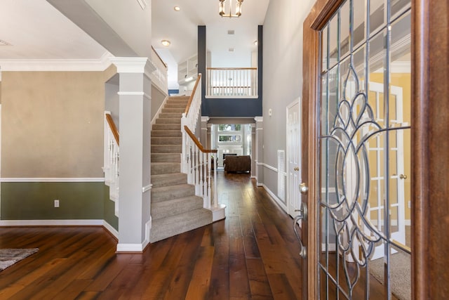 entrance foyer with dark hardwood / wood-style floors and ornamental molding