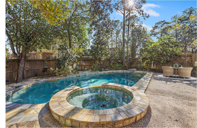 view of pool with an in ground hot tub and a patio