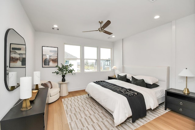 bedroom with ceiling fan and light wood-type flooring