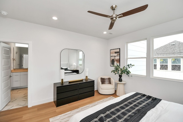 bedroom featuring ensuite bath, ceiling fan, and light hardwood / wood-style flooring