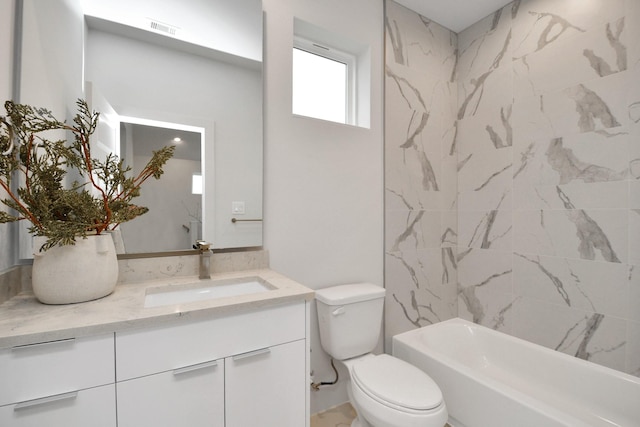 full bathroom featuring vanity, toilet, and tiled shower / bath combo