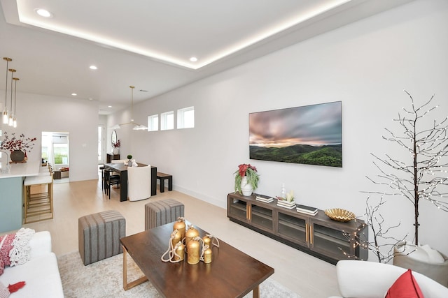 living room with light wood-type flooring and plenty of natural light