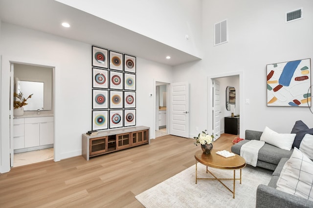 living room featuring hardwood / wood-style floors and a high ceiling