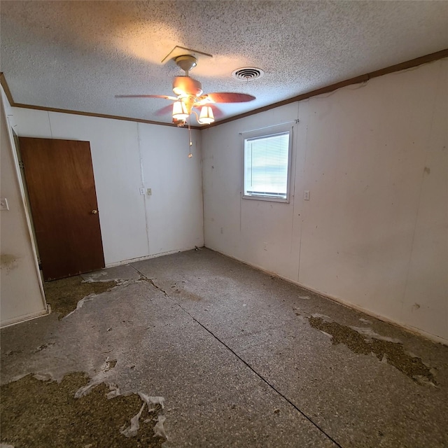 spare room featuring ceiling fan and a textured ceiling