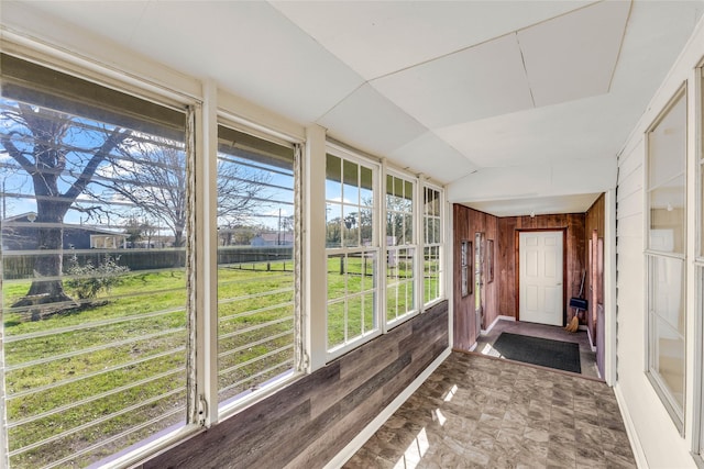 unfurnished sunroom with vaulted ceiling and a wealth of natural light