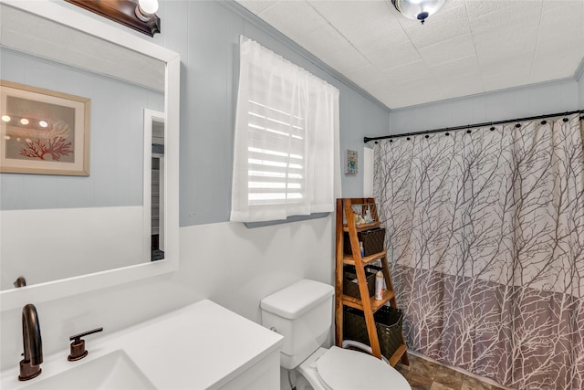 bathroom with a shower with shower curtain, toilet, crown molding, and sink