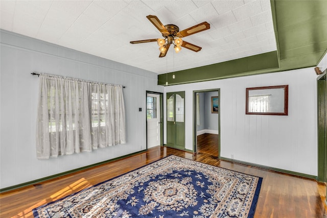 interior space with dark hardwood / wood-style floors and ceiling fan