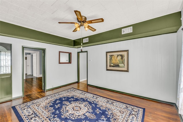 spare room with dark hardwood / wood-style floors and ceiling fan