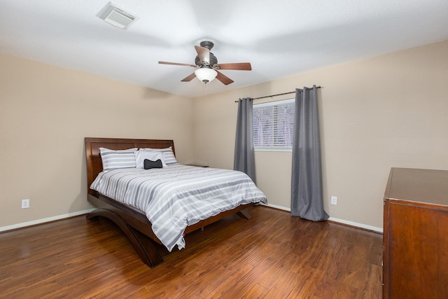 bedroom with ceiling fan and dark wood-type flooring