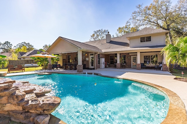 view of swimming pool with pool water feature, a patio area, and an outdoor hangout area