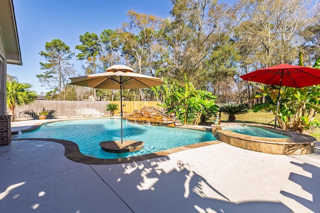 view of pool featuring pool water feature, a patio area, and an in ground hot tub