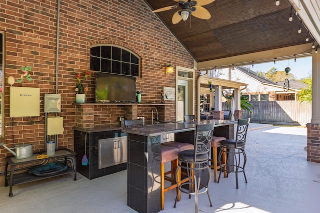 view of patio / terrace featuring ceiling fan and a wet bar