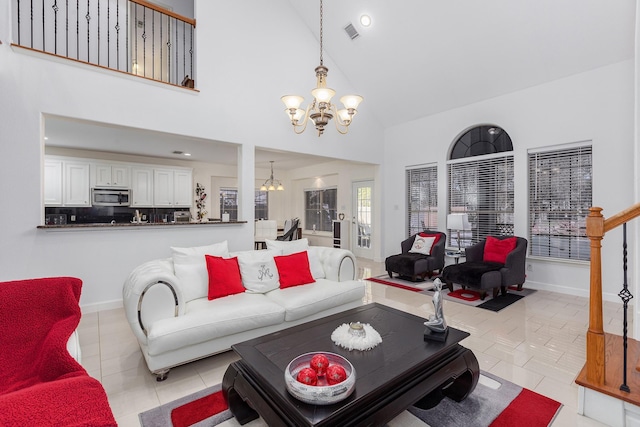 living room with light tile patterned floors, high vaulted ceiling, and an inviting chandelier