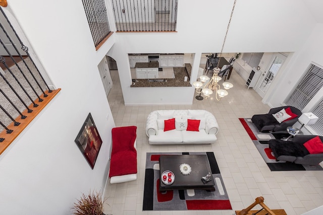 tiled living room with a towering ceiling and an inviting chandelier