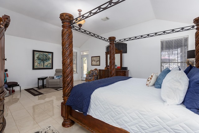 bedroom with lofted ceiling and light tile patterned floors