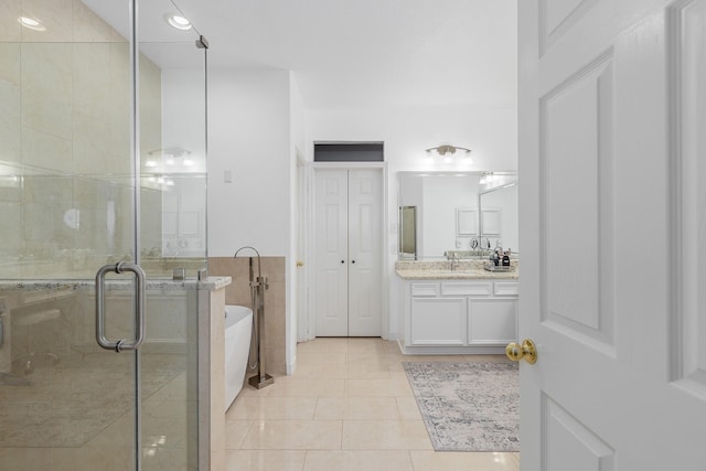 bathroom featuring tile patterned floors, vanity, and shower with separate bathtub