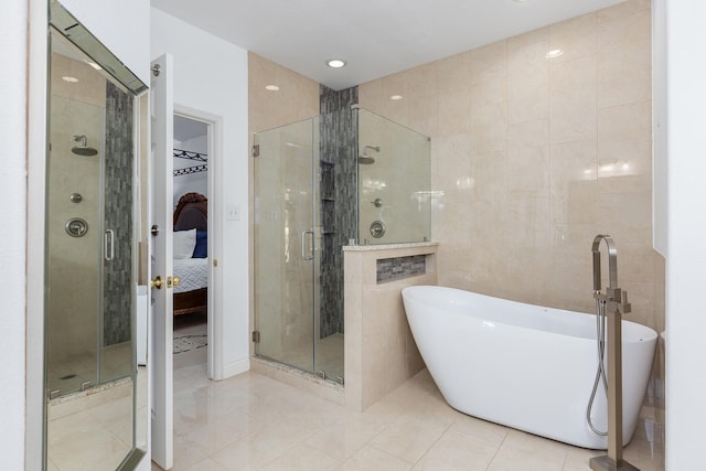 bathroom with separate shower and tub and tile patterned floors