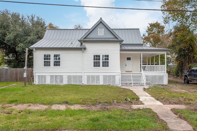 view of front of property with a porch and a front lawn