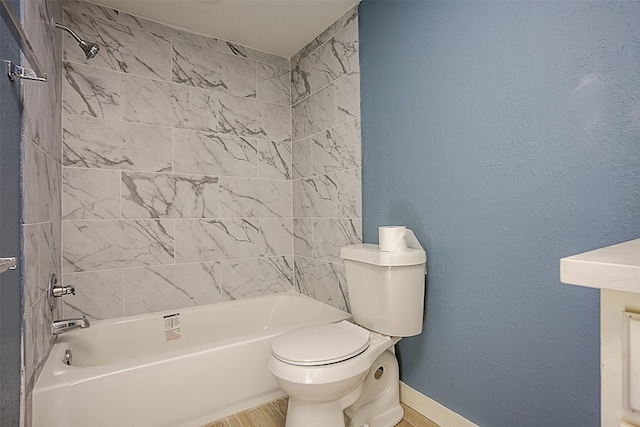 bathroom featuring toilet, hardwood / wood-style floors, and washtub / shower combination