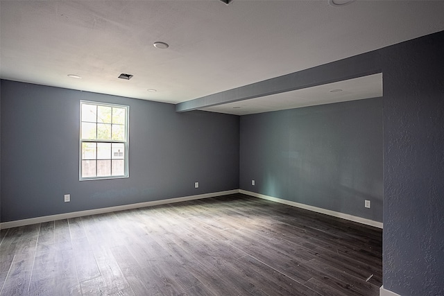 unfurnished room with dark hardwood / wood-style floors