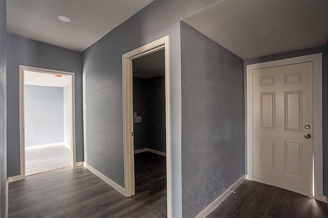 corridor with dark hardwood / wood-style floors