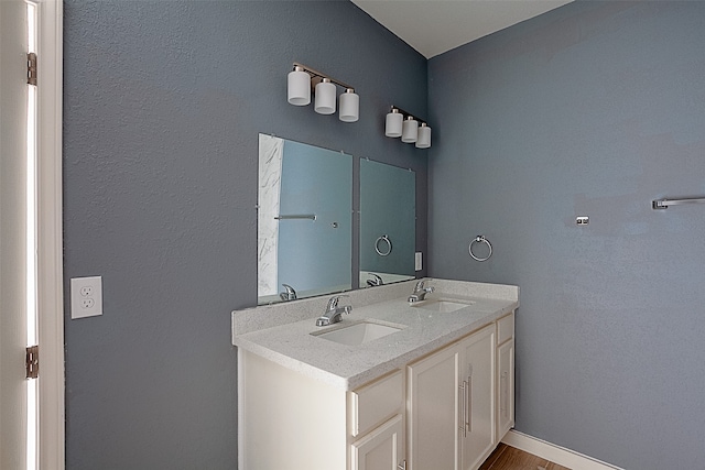 bathroom with hardwood / wood-style flooring and vanity