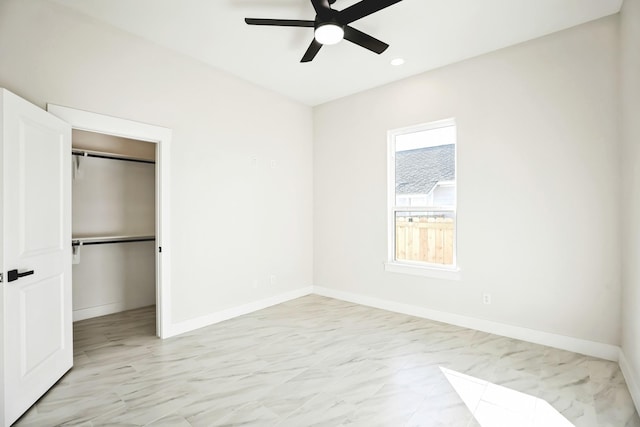 unfurnished bedroom with ceiling fan and a closet