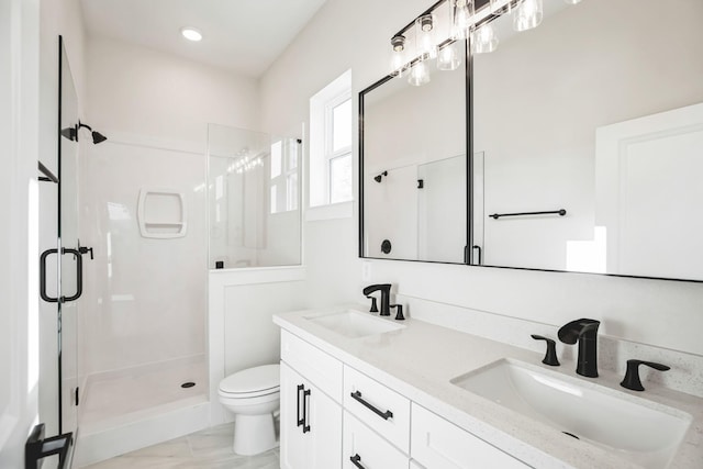 bathroom featuring vanity, toilet, and walk in shower