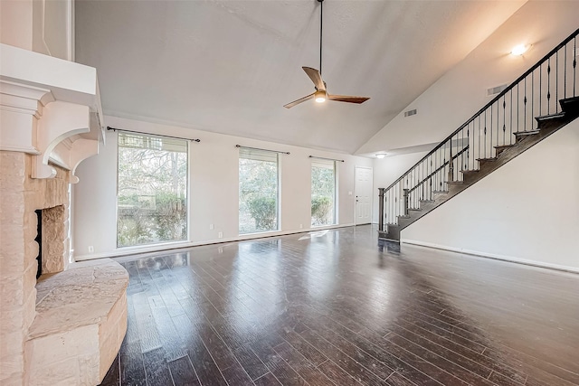 unfurnished living room featuring a stone fireplace, ceiling fan, high vaulted ceiling, and hardwood / wood-style flooring