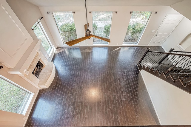 unfurnished living room with dark hardwood / wood-style flooring and a wealth of natural light