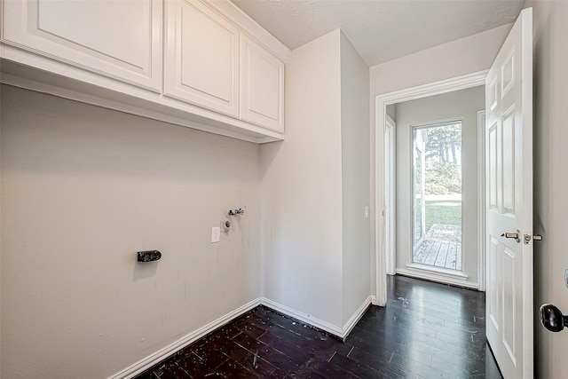 washroom featuring cabinets, dark hardwood / wood-style flooring, and electric dryer hookup