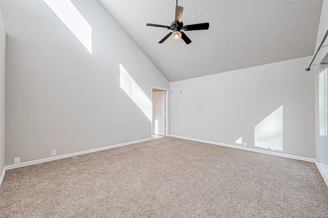 carpeted empty room with a textured ceiling, ceiling fan, and lofted ceiling