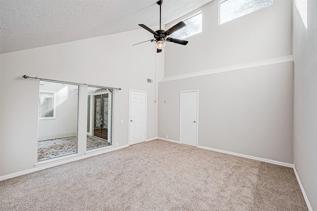 interior space with ceiling fan, a textured ceiling, and high vaulted ceiling