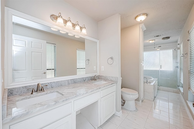 full bathroom with plus walk in shower, a healthy amount of sunlight, tile patterned flooring, toilet, and vanity