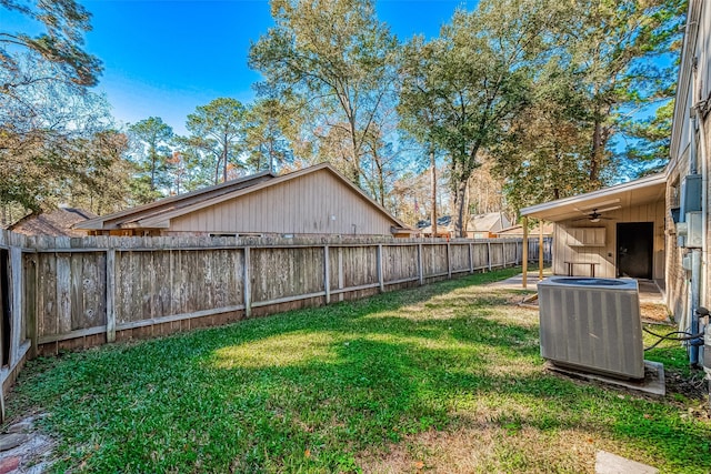 view of yard featuring ceiling fan and central air condition unit