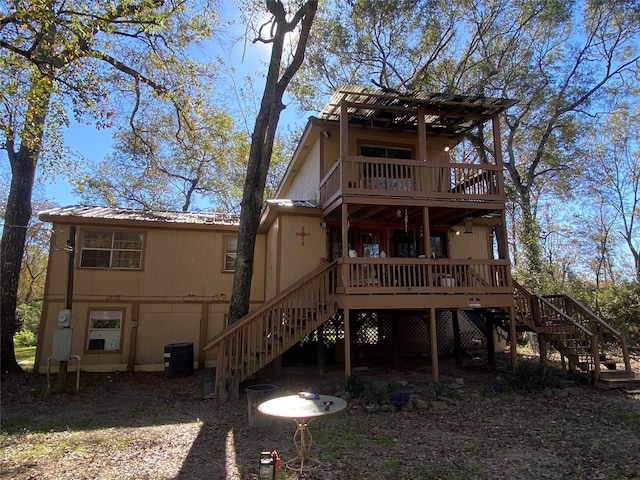 rear view of house with cooling unit, a pergola, and a wooden deck