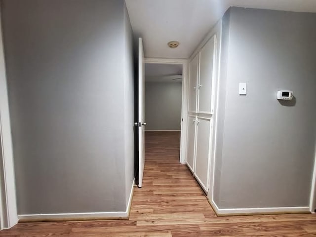 hallway with light hardwood / wood-style floors