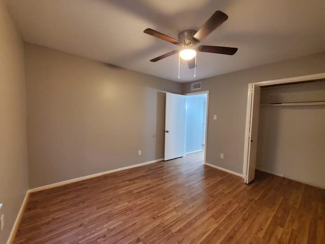 unfurnished bedroom featuring a closet, ceiling fan, and hardwood / wood-style flooring