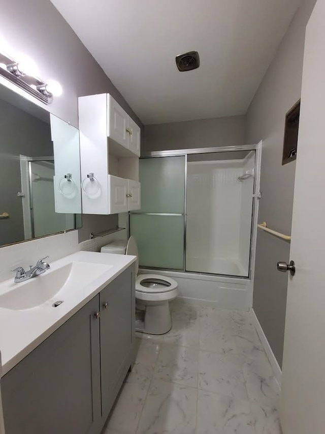 full bathroom with vanity, toilet, and bath / shower combo with glass door