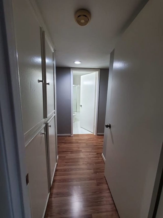 hallway featuring dark hardwood / wood-style flooring