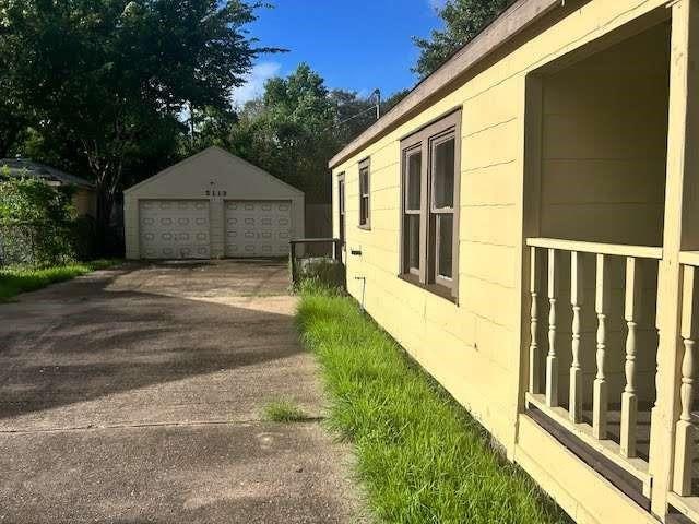 view of side of property with an outbuilding and a garage